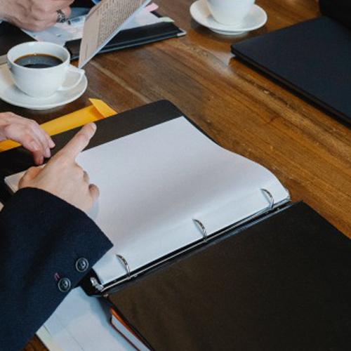 Business professional preparing software development project plan in meeting with Skilled Workers Cloud